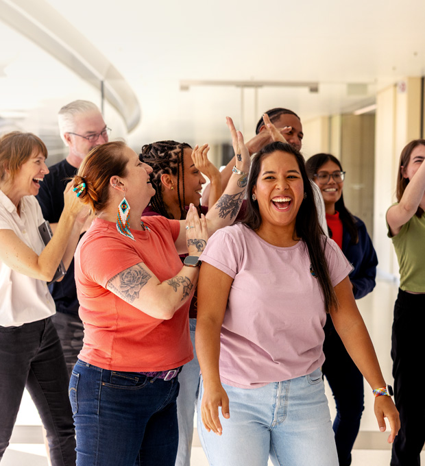 A group of employees are gathered together having a good time.