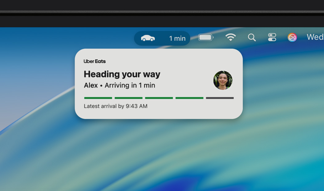 MacBook Pro, Live Activity notification shows an Uber Eats is on the way